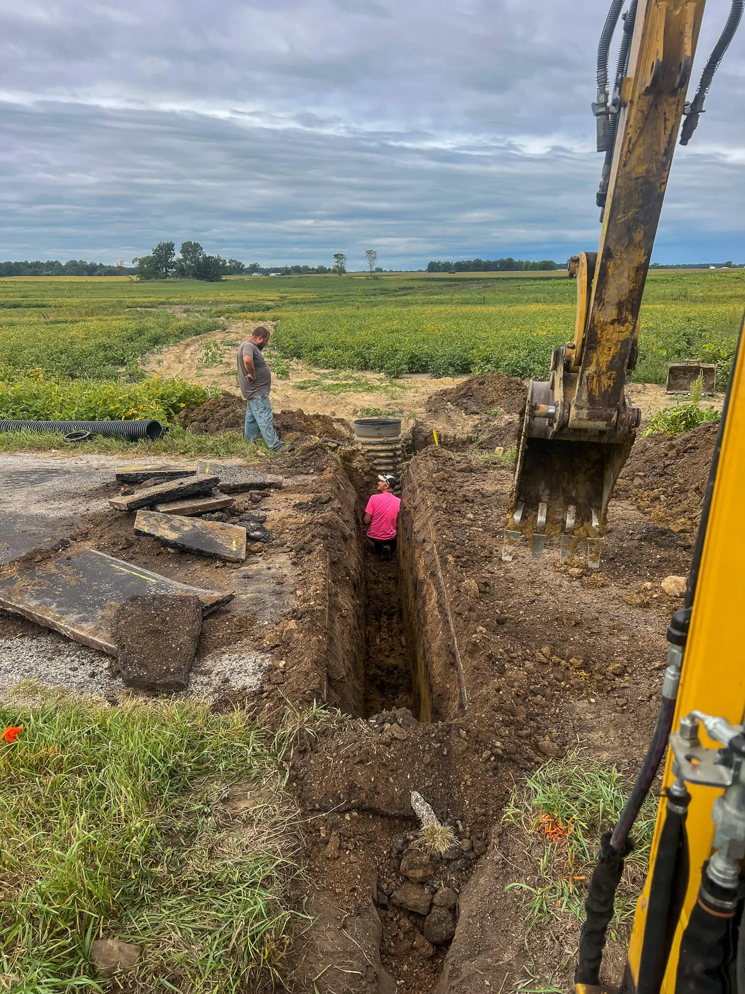 Pulling an old tile riser during a farm drainage repair